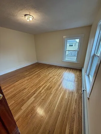 a view of an empty room and wooden floor