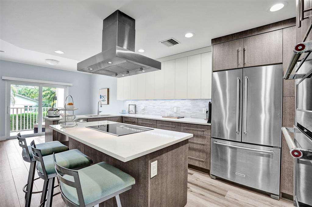 5900 Old Ocean Boulevard, Unit A9 Ocean Ridge, FL 33435 - Photo 11 of 29 a kitchen with stainless steel appliances a refrigerator a sink a stove and white cabinets