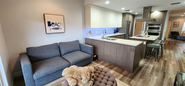 a living room with furniture and kitchen view