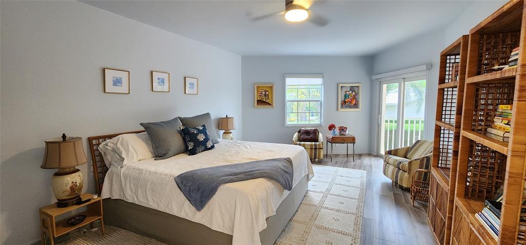 5900 Old Ocean Boulevard, Unit A9 Ocean Ridge, FL 33435 - Photo 14 of 29 a bedroom with bed and wooden floor