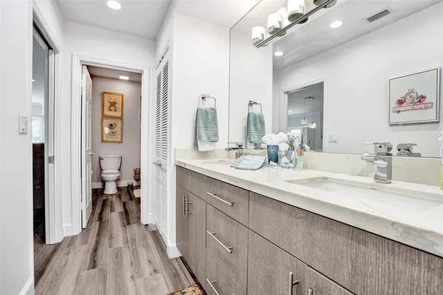 a bathroom with a double vanity sink and a mirror