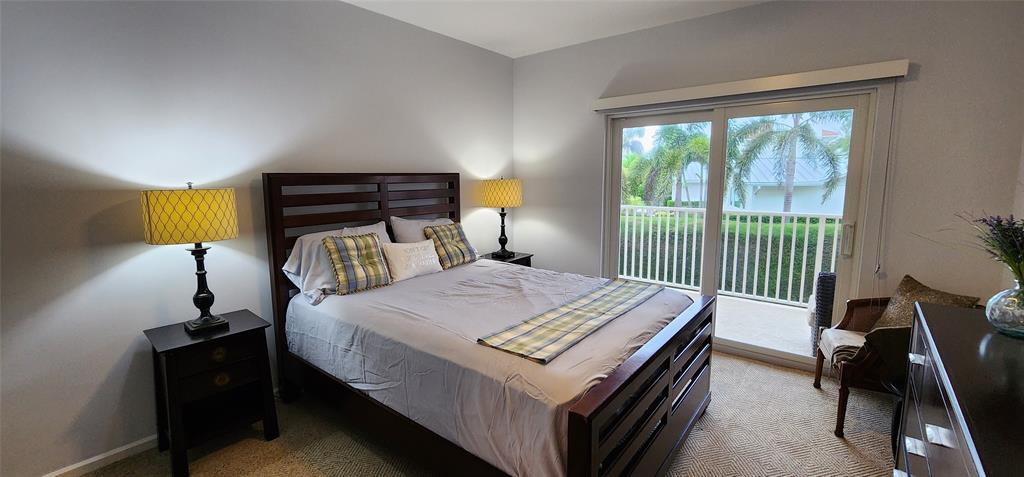 5900 Old Ocean Boulevard, Unit A9 Ocean Ridge, FL 33435 - Photo 19 of 29 a bed sitting in a bedroom next to a window