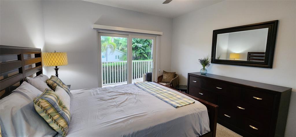 5900 Old Ocean Boulevard, Unit A9 Ocean Ridge, FL 33435 - Photo 20 of 29 a bedroom with a bed and a flat tv screen on the dresser