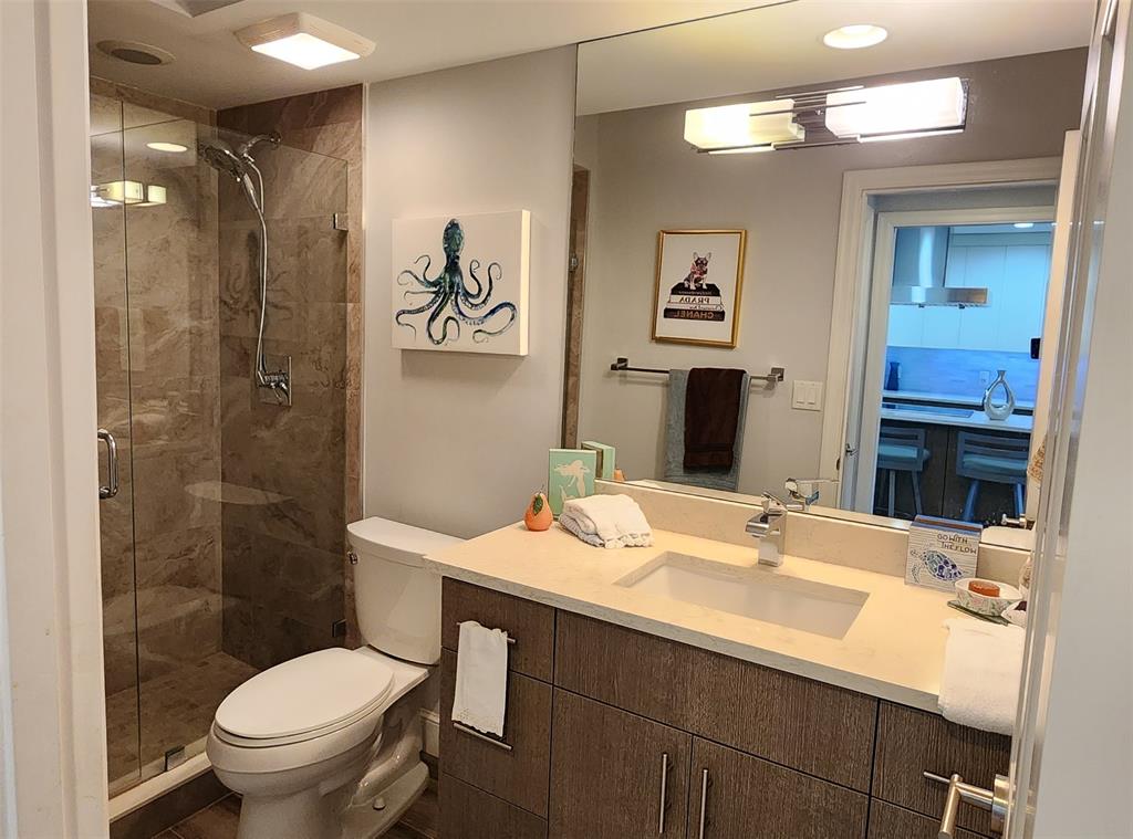 5900 Old Ocean Boulevard, Unit A9 Ocean Ridge, FL 33435 - Photo 21 of 29 a bathroom with a sink a toilet a mirror and shower