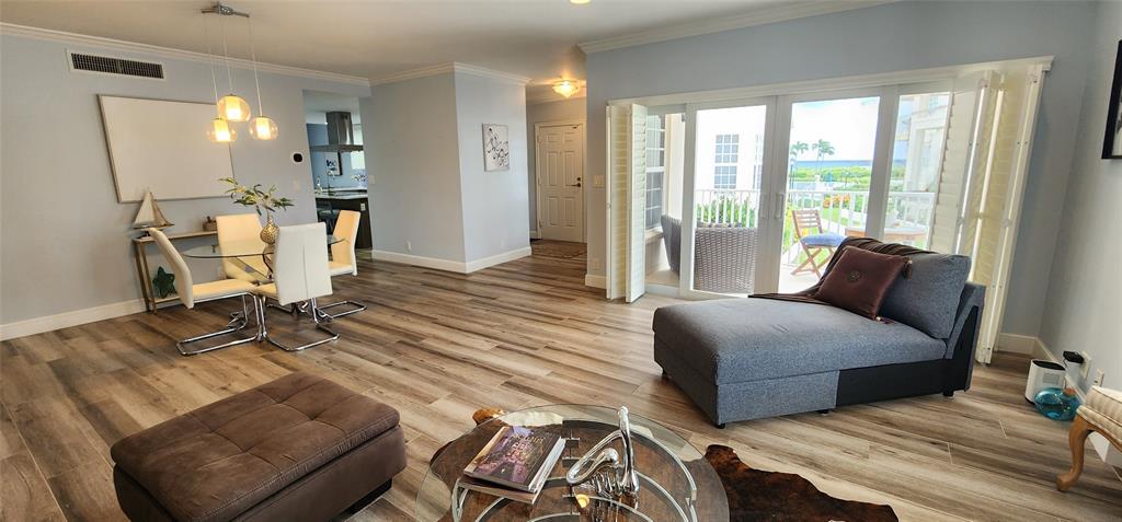 5900 Old Ocean Boulevard, Unit A9 Ocean Ridge, FL 33435 - Photo 6 of 29 a living room with furniture and a wooden floor