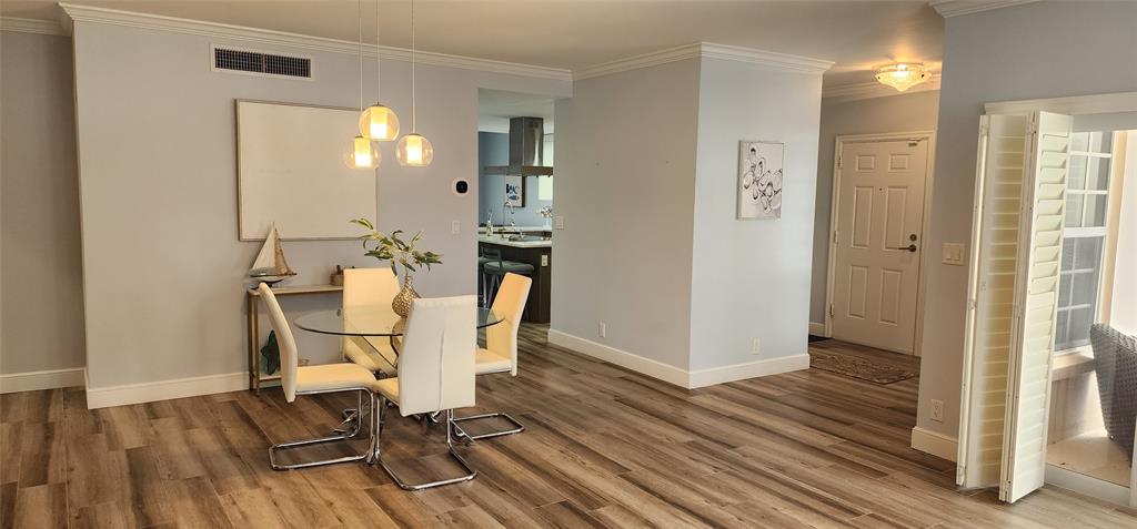 5900 Old Ocean Boulevard, Unit A9 Ocean Ridge, FL 33435 - Photo 8 of 29 a view of a room with wooden floor table and chairs