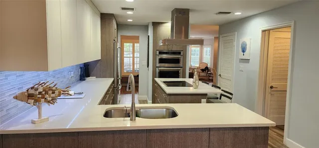 a kitchen with a sink a stove and a refrigerator