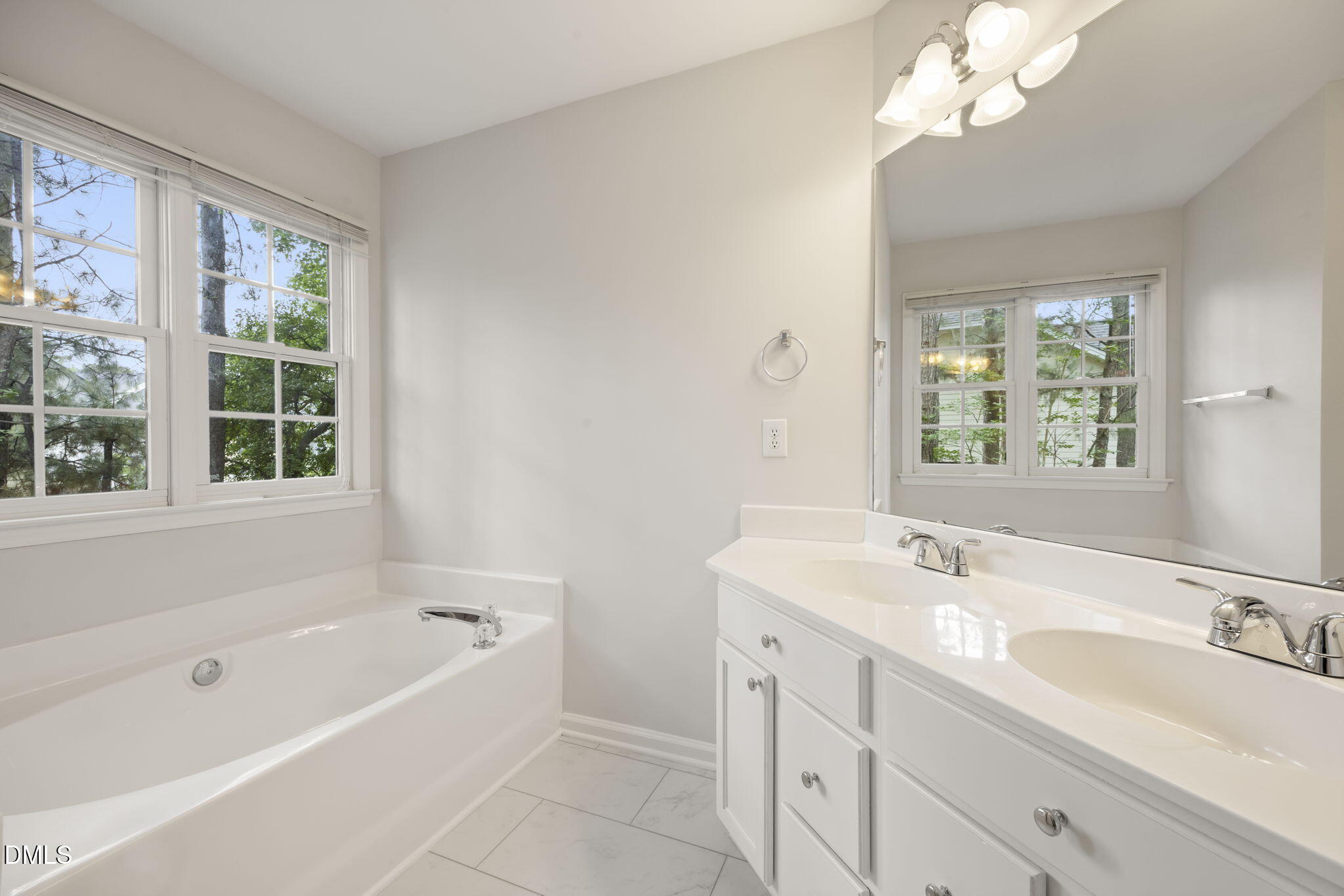 1008 Scotts Ridge Trail Apex, NC 27502 - Photo 31 of 57 a bathroom with a tub a sink a large mirror and a bathtub next to a window