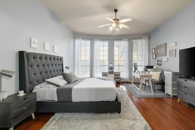 a spacious bedroom with a large bed and a chandelier