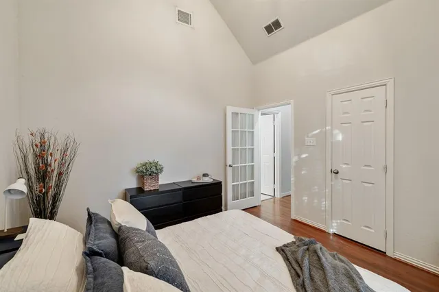 a bedroom with a bed and a potted plant