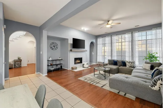 a living room with furniture fireplace and a large window
