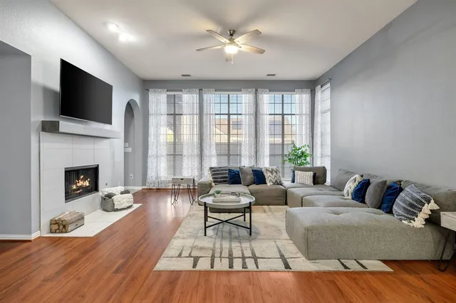 a living room with furniture fireplace and flat screen tv