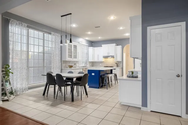 a dining area with furniture and a large window