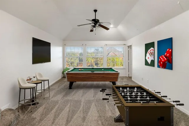 a room with pool table and flat screen tv