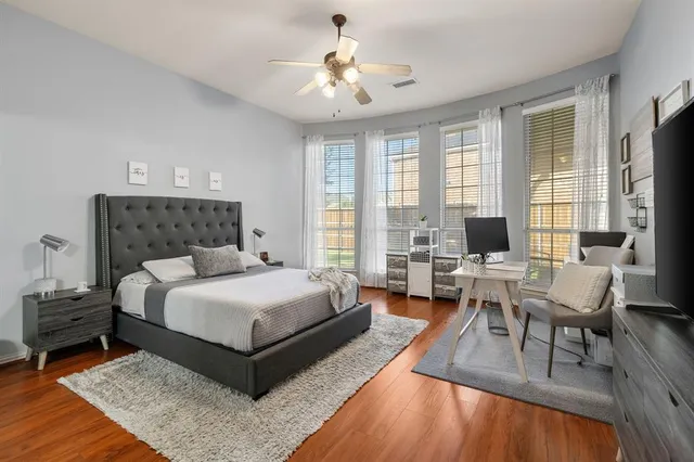 a spacious bedroom with a bed and a couch