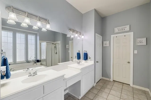 a bathroom with a sink double vanity and a mirror