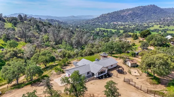 an aerial view of a houses with a yard