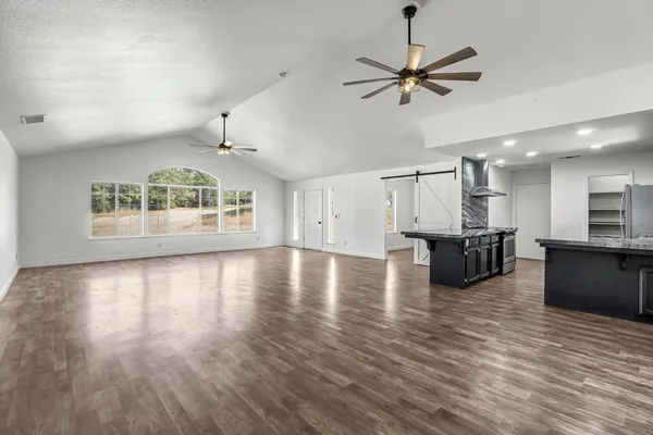 a view of a kitchen with microwave and a table