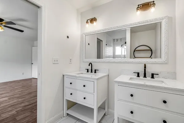 a bathroom with a sink a toilet and a mirror