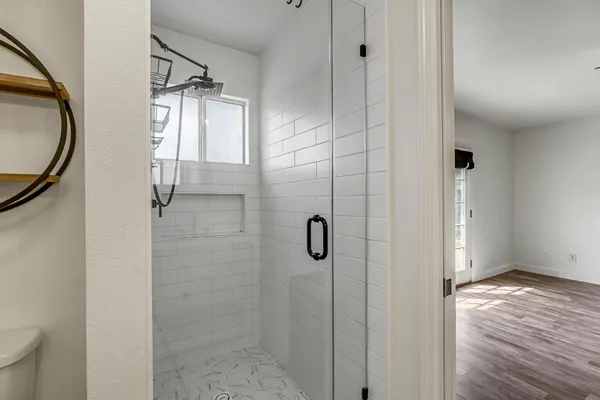 a view of an entryway with wooden floor