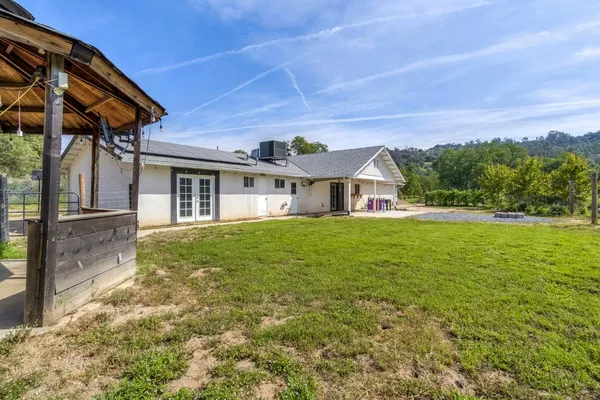 a view of a house with a yard and ocean view