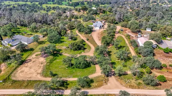 an aerial view of residential house and sandy dunes