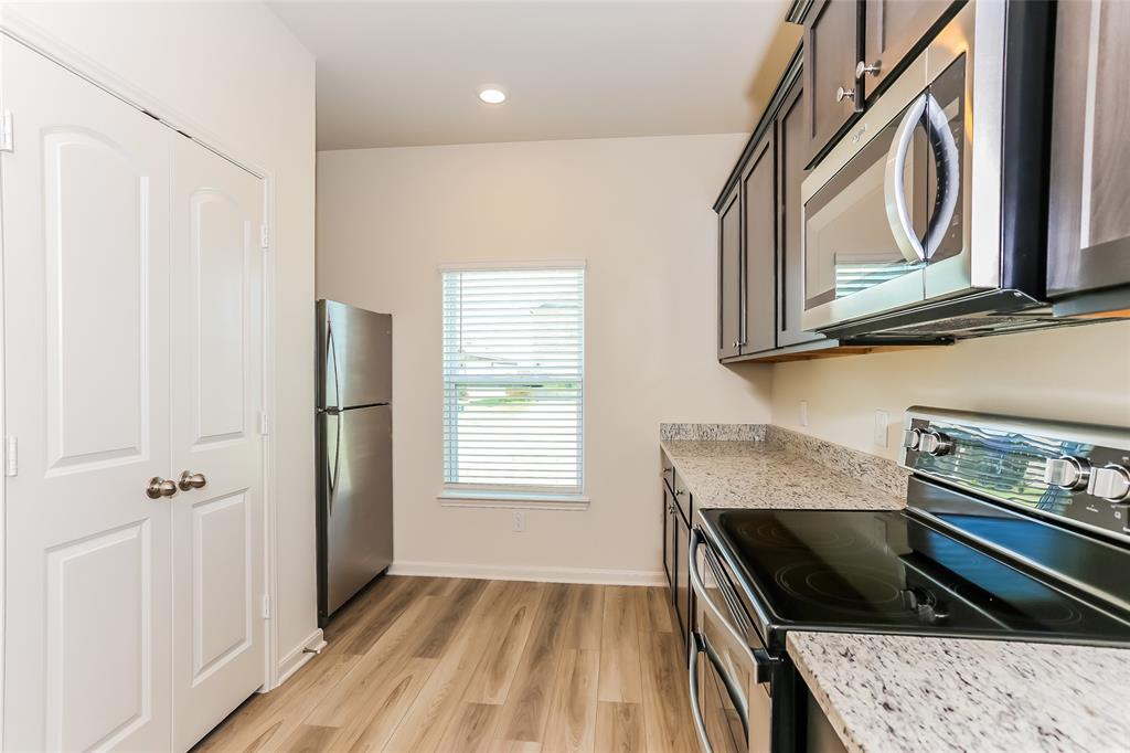 140 Switchback Hl Road Newark, TX 76071 - Photo 12 of 17 a kitchen with a stove and a microwave