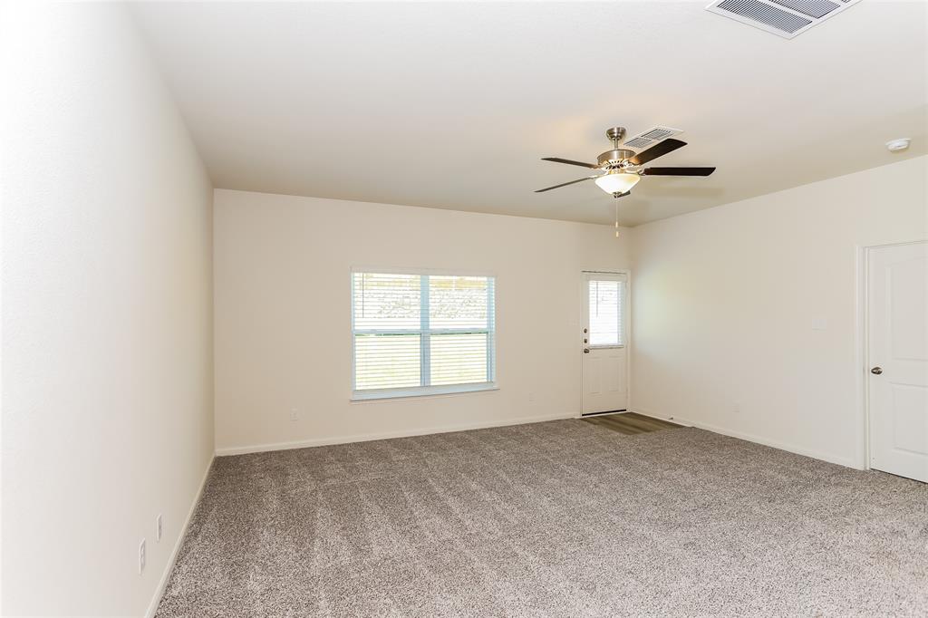 140 Switchback Hl Road Newark, TX 76071 - Photo 14 of 17 an empty room with windows and fan