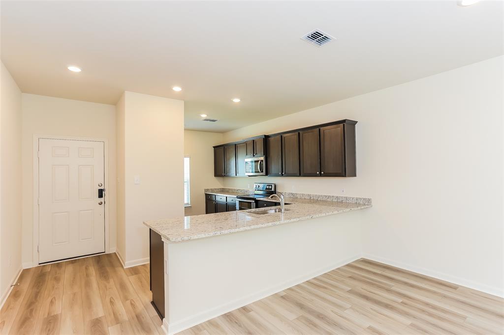 140 Switchback Hl Road Newark, TX 76071 - Photo 10 of 17 a kitchen with a sink stainless steel appliances and cabinets