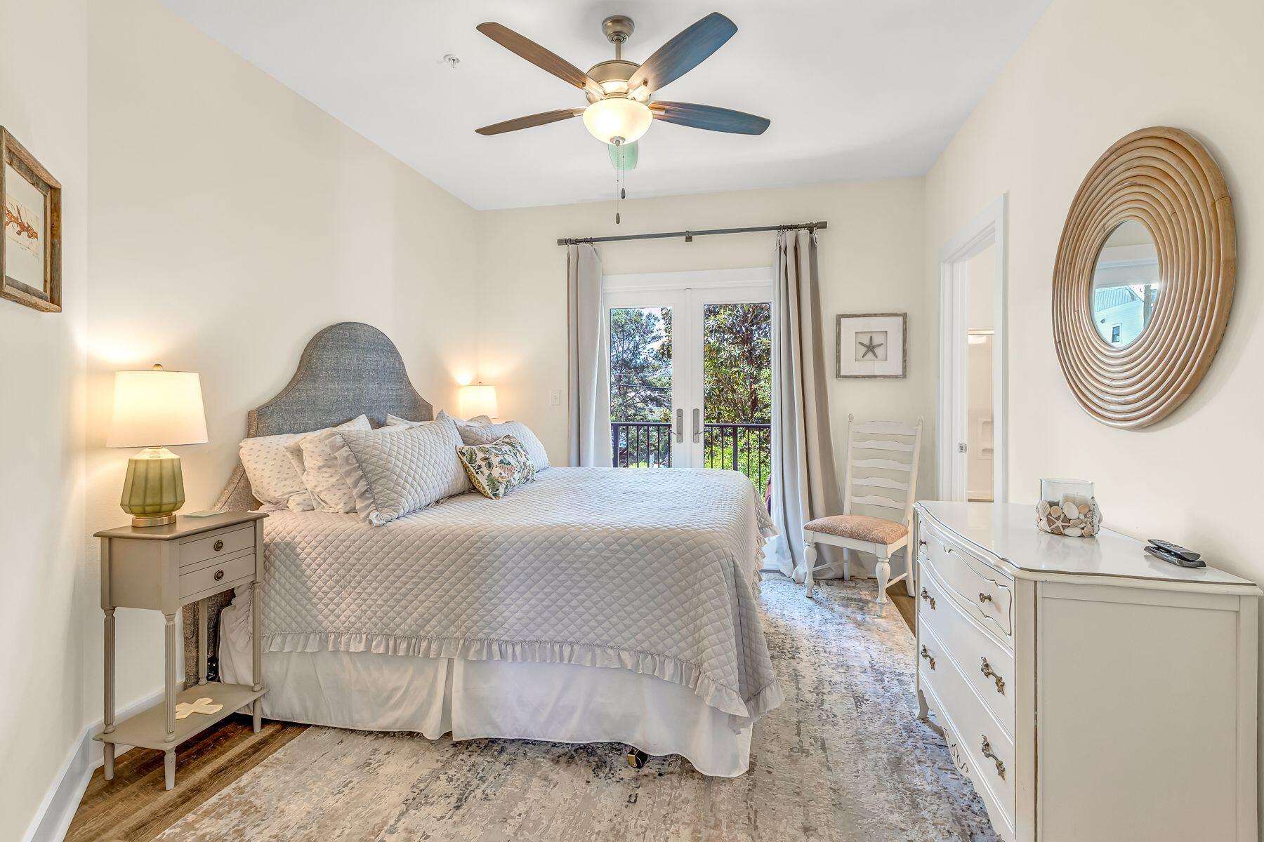 4000 West County Highway 30A, Unit 322 Santa Rosa Beach, FL 32459 - Photo 13 of 30 a bedroom with a bed and a chandelier