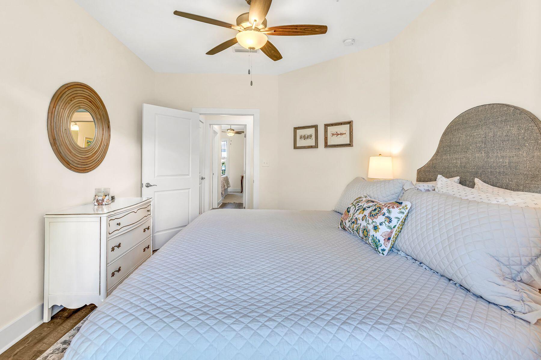 4000 West County Highway 30A, Unit 322 Santa Rosa Beach, FL 32459 - Photo 14 of 30 a bedroom with a bed and a chandelier
