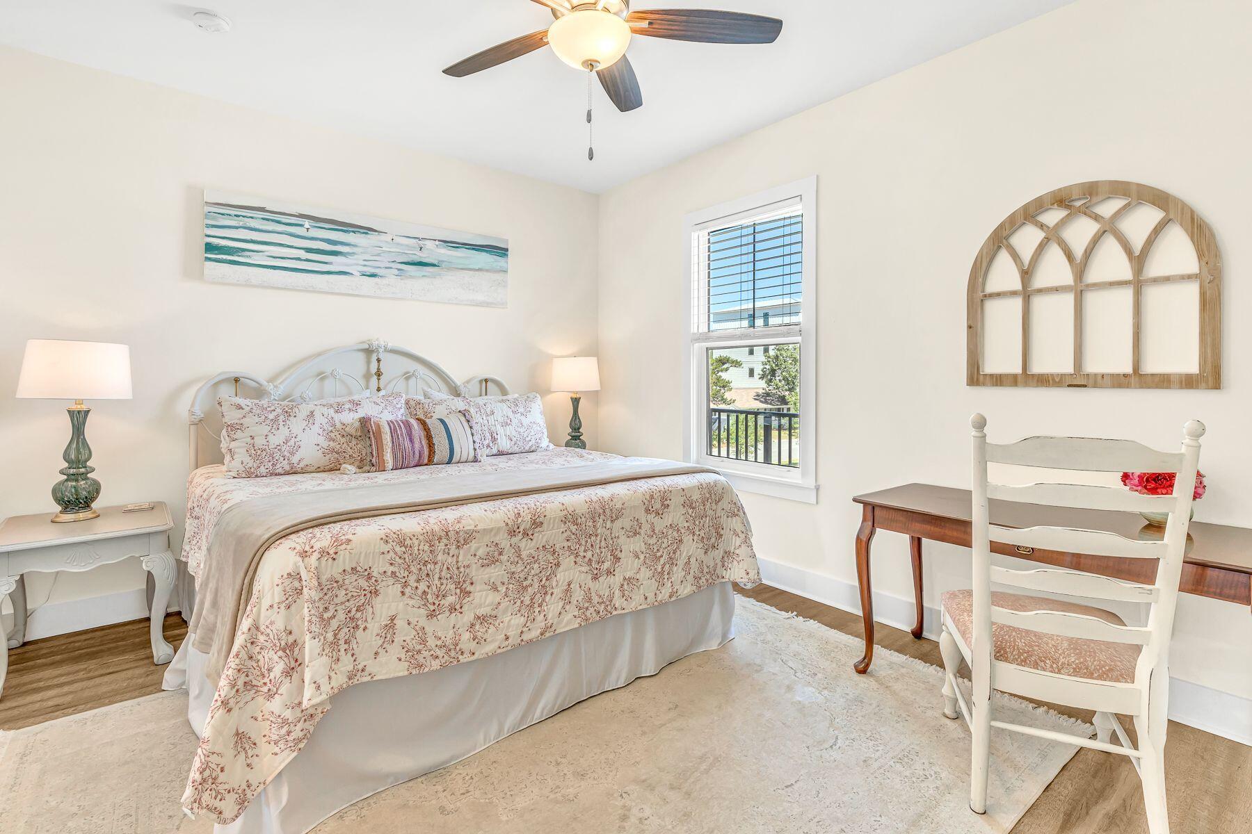 4000 West County Highway 30A, Unit 322 Santa Rosa Beach, FL 32459 - Photo 16 of 30 a bedroom with a bed and a chandelier