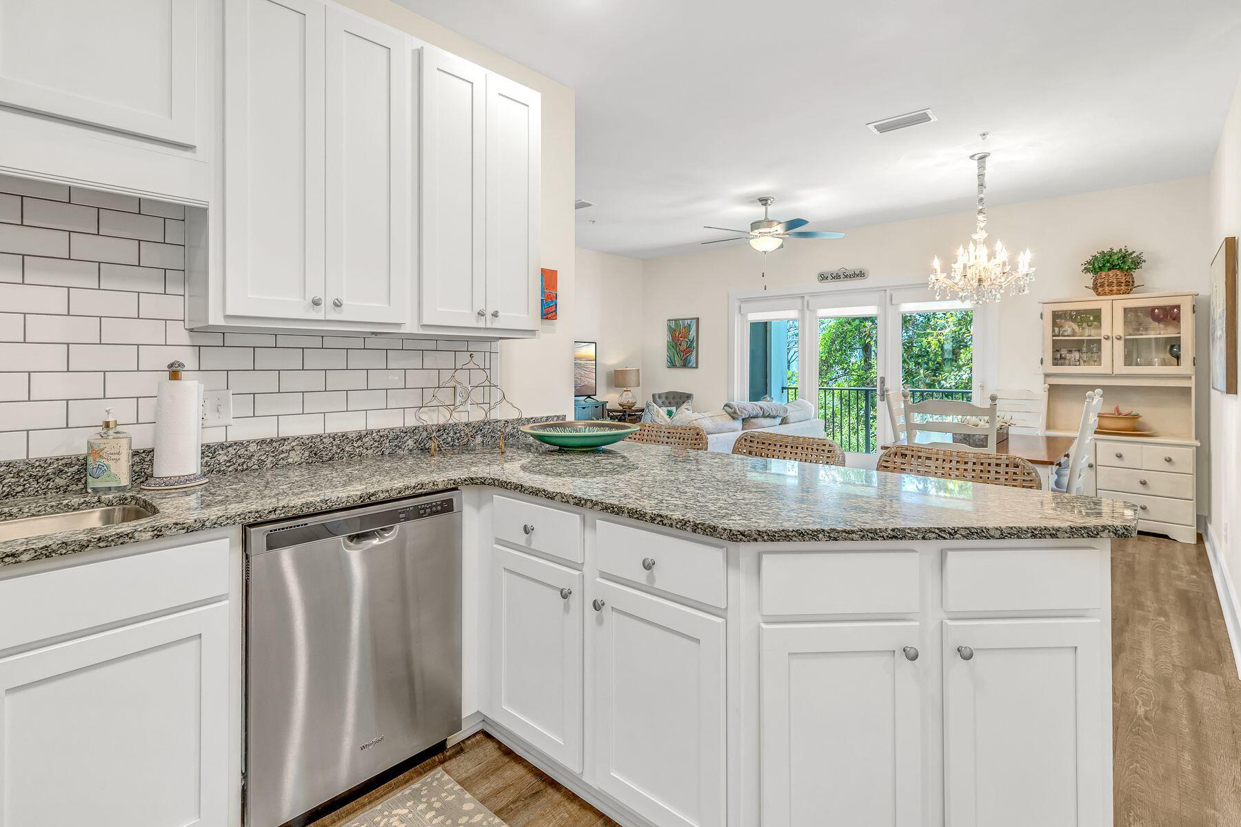 4000 West County Highway 30A, Unit 322 Santa Rosa Beach, FL 32459 - Photo 2 of 30 a kitchen with granite countertop white cabinets and a sink