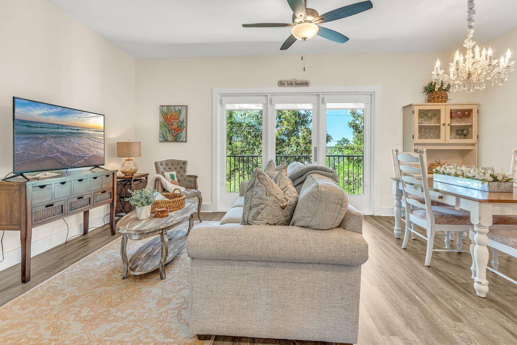 4000 West County Highway 30A, Unit 322 Santa Rosa Beach, FL 32459 - Photo 10 of 30 a living room with furniture and a flat screen tv with wooden floor