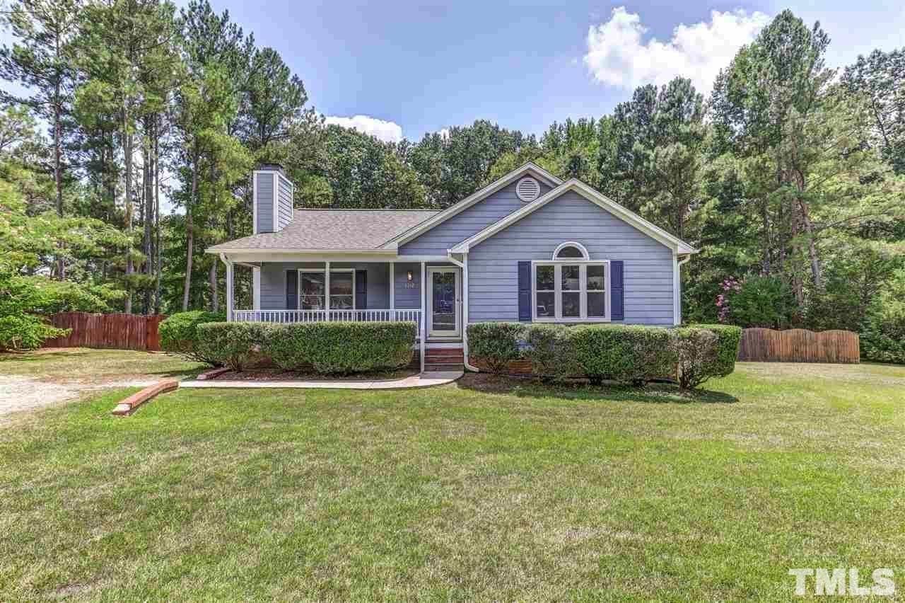 4312 Rockside Hills Drive Raleigh, NC 27603 - Photo 1 of 5 a front view of a house with a yard