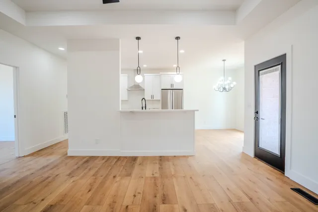 a view of a kitchen with wooden floor