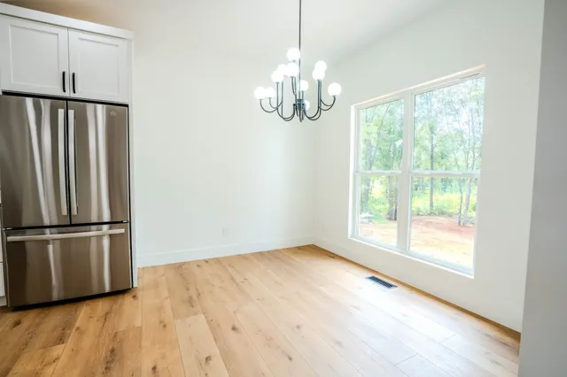a kitchen with stainless steel appliances a refrigerator sink and cabinets