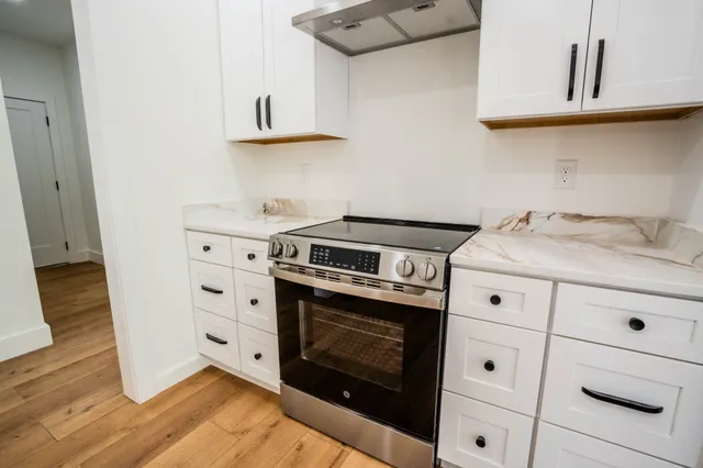 a kitchen with stainless steel appliances a sink stove and refrigerator