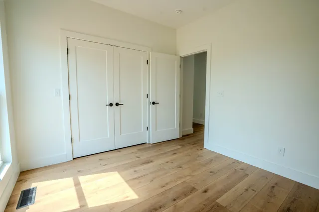 a bathroom with double vanity and a mirror