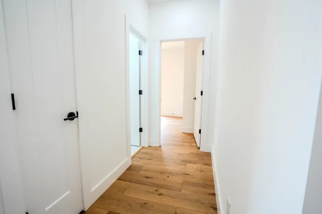 a bathroom with a double vanity sink a mirror and a bathtub