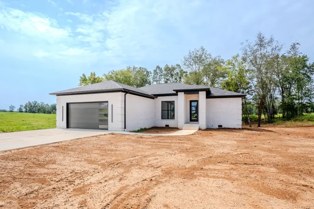 a view of a house with a yard and garage