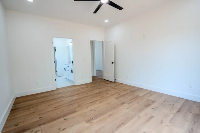 a spacious bathroom with a double vanity sink mirror and shower