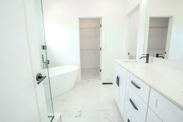 a bathroom with a bathtub and a shower