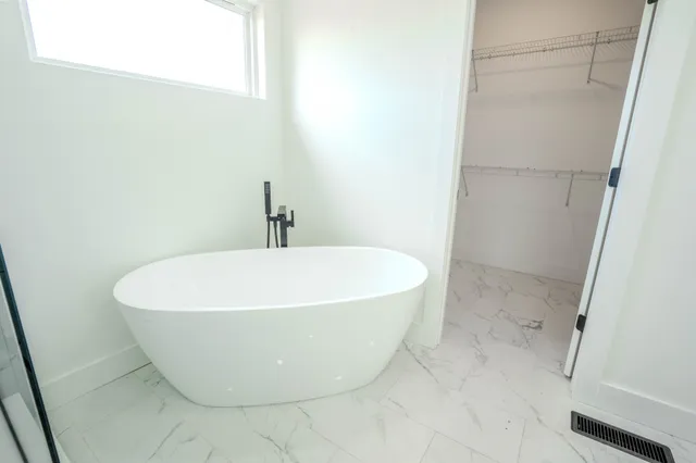 a bathroom with a granite countertop sink a shower and a mirror