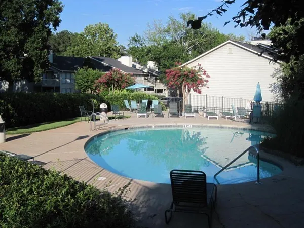 a view of a swimming pool with an outdoor seating