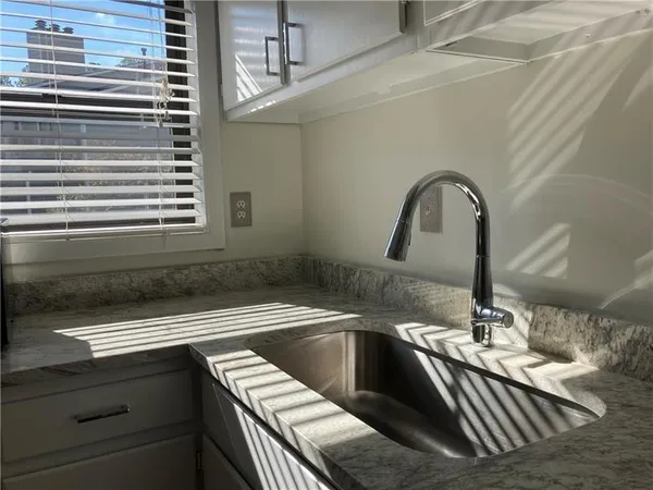 a kitchen with a sink and a window