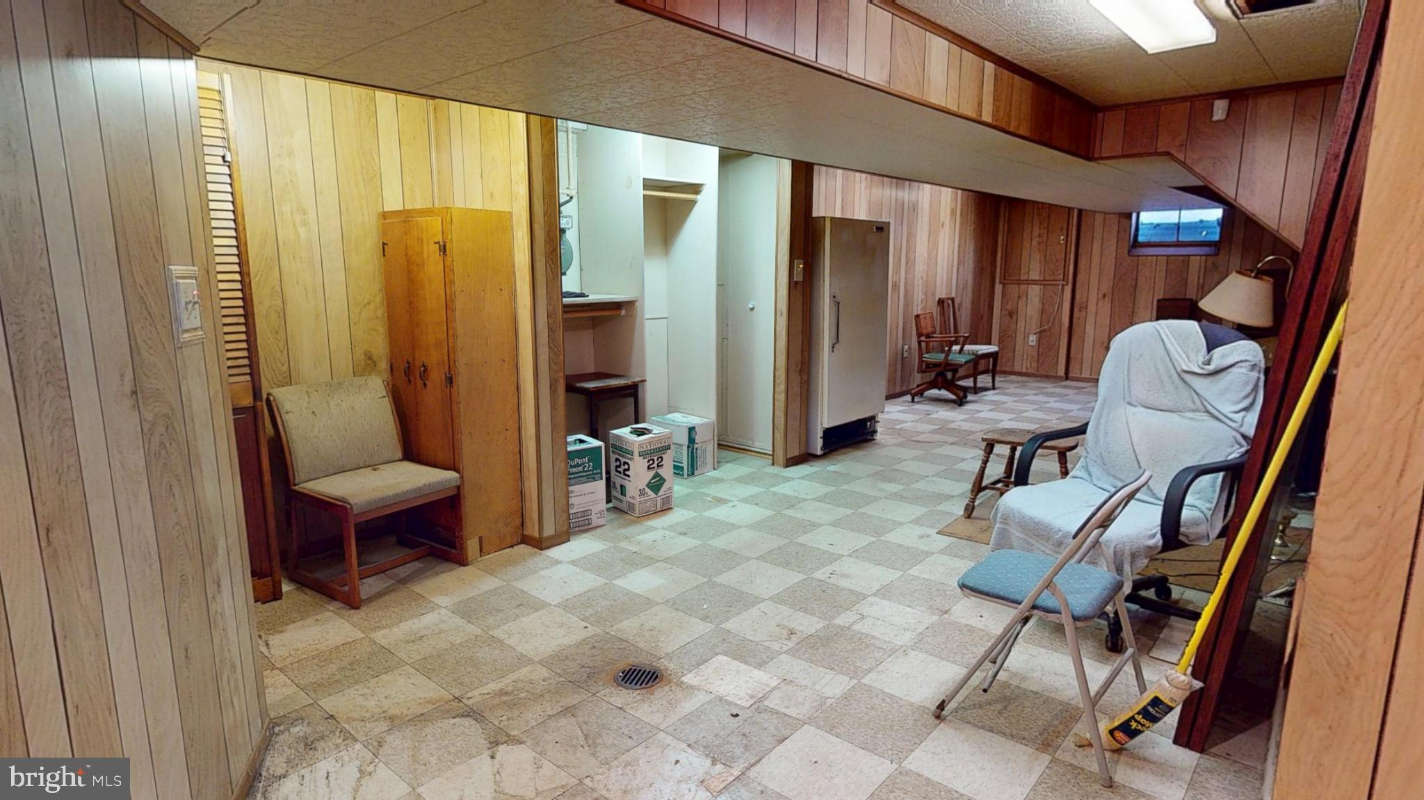 Spacious basement with wood paneling charm.