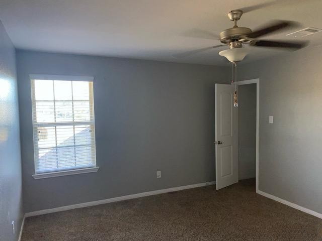 18003 Svensson Slade Lane Houston, TX 77044 - Photo 15 of 24 an empty room with a ceiling fan and a window