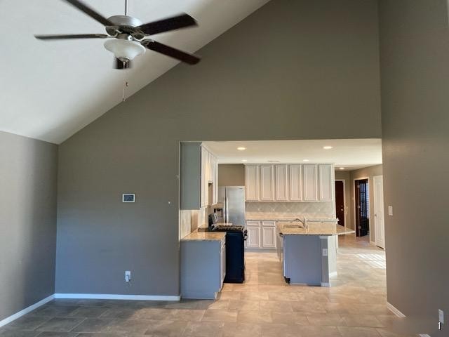 18003 Svensson Slade Lane Houston, TX 77044 - Photo 7 of 24 a view of kitchen with kitchen island wooden cabinets and refrigerator