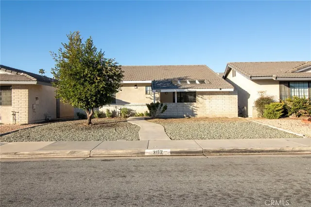 a front view of a house with a yard and a garage